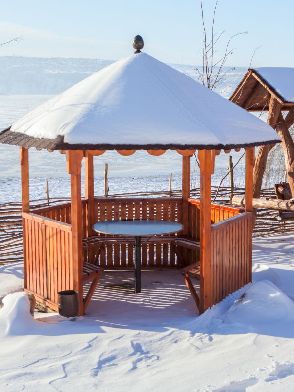 wood gazebo covered with snow